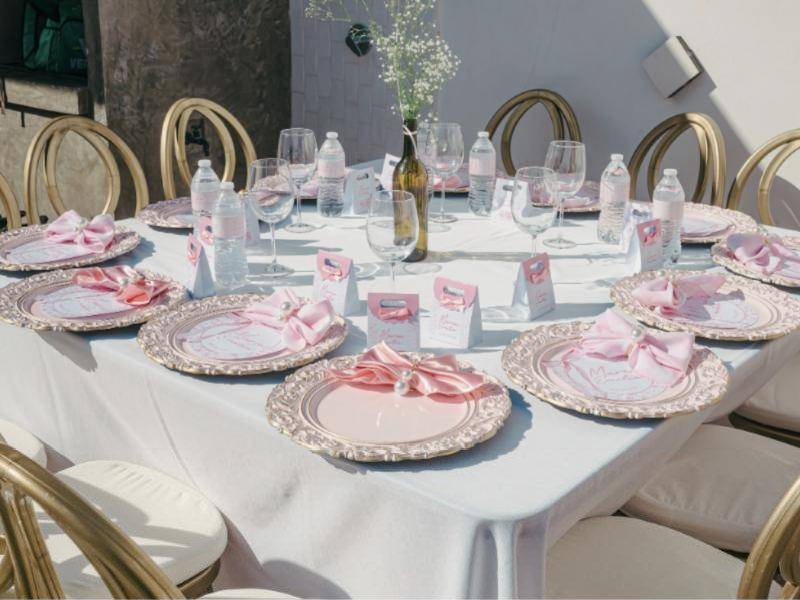 Tables set with blush napkins and gold chairs